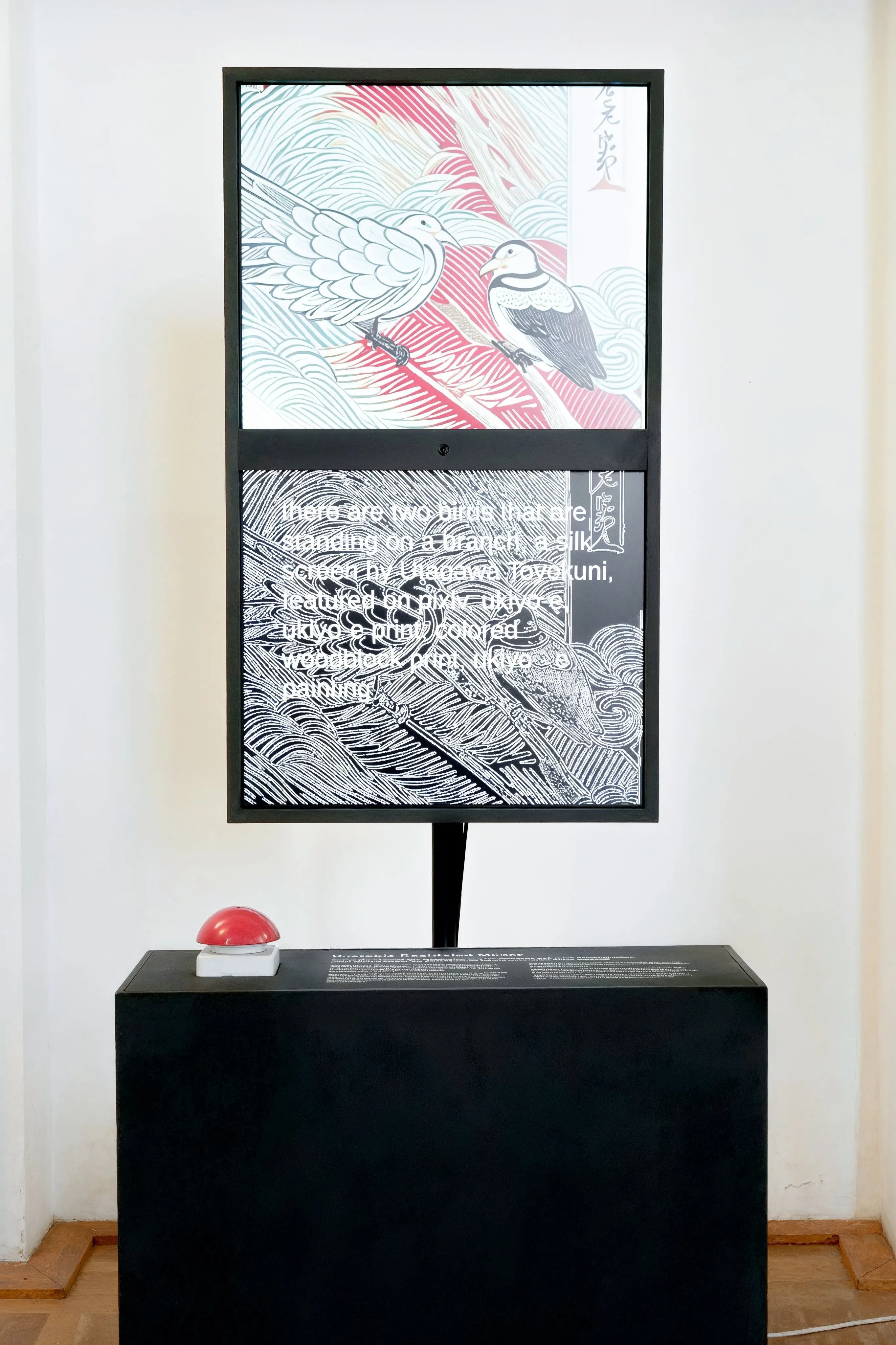 Front view of unStable Mirror against a white wall: two stacked screens in a black frame on a pole, a generated woodblock-style image of two birds above its edge map with the caption text, and the black plinth with the red buzzer below